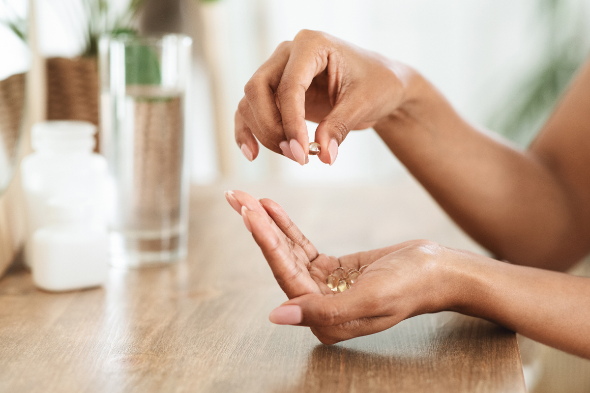 A woman's hand holds fertility boosting supplements. 